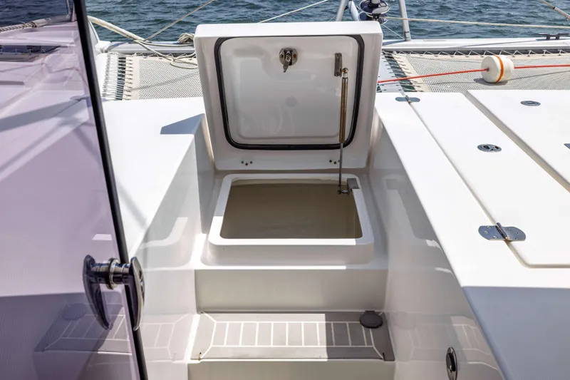 Slide: The Image of 2022 Leopard 42 yacht deck with open storage compartment, showcasing sleek design and ocean backdrop. - 15
