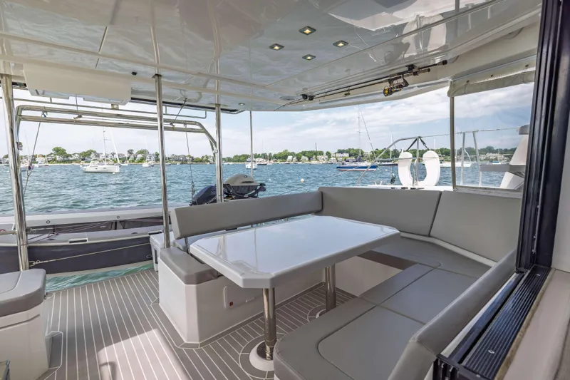 Slide: The Image of Luxurious Leopard 42 yacht interior with seating area, overlooking serene waters and anchored boats. - 28