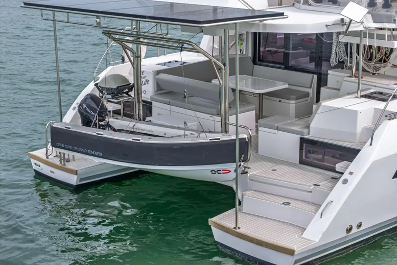 Slide: The Image of 2022 Leopard 42 yacht with solar panels and tender, docked on calm water. - 13
