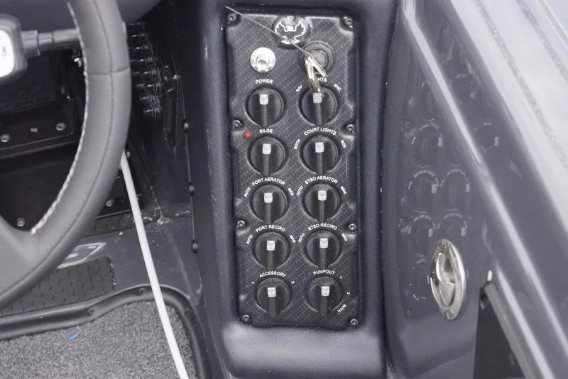 Slide: The Image of Control panel of a 2026 Phoenix 819 ZXL boat with various switches and key ignition. - 14