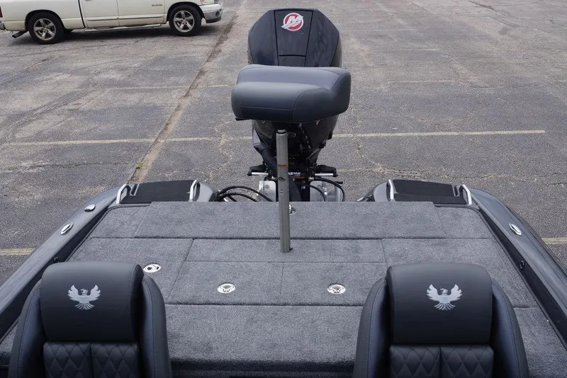 Slide: The Image of 2026 Phoenix 819 ZXL boat interior with cushioned seats and motor in parking lot. - 22