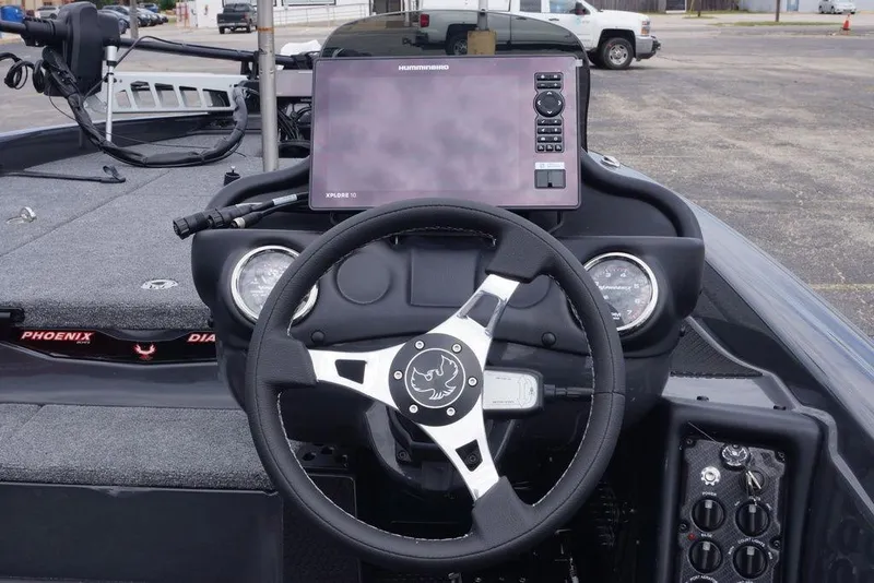 Slide: The Image of Steering wheel and dashboard of 2026 Phoenix 819 ZXL boat with navigation display. - 24