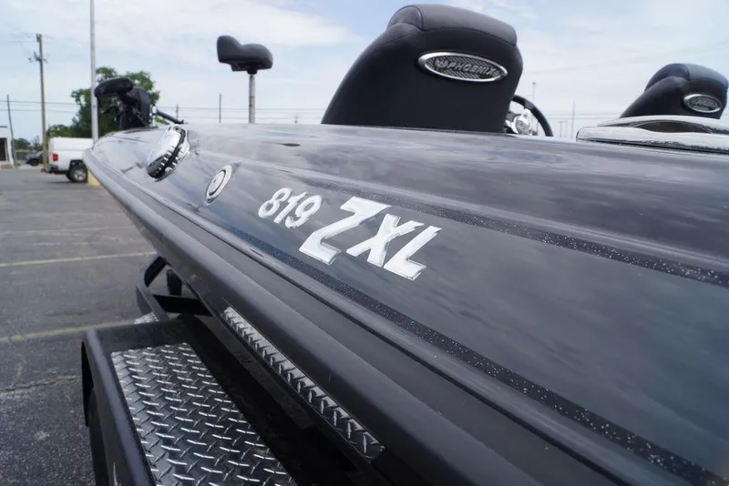 Slide: The Image of 2026 Phoenix 819 ZXL boat, close-up view of model name on sleek exterior. - 5