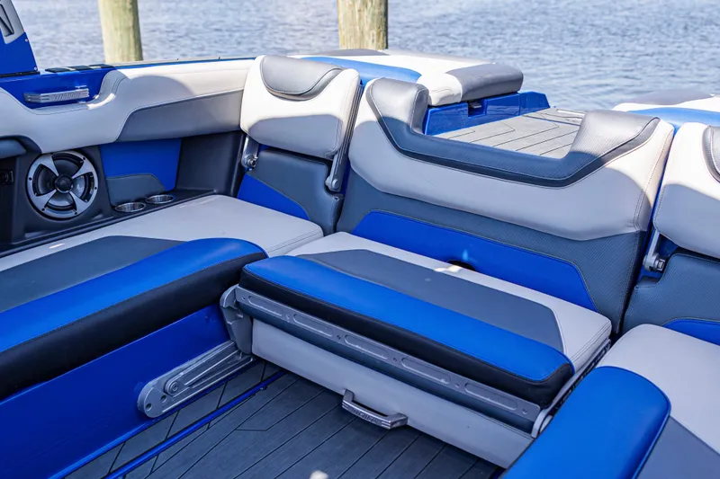 Slide: The Image of Interior of a 2017 Malibu M235 boat with blue and gray seating. - 17