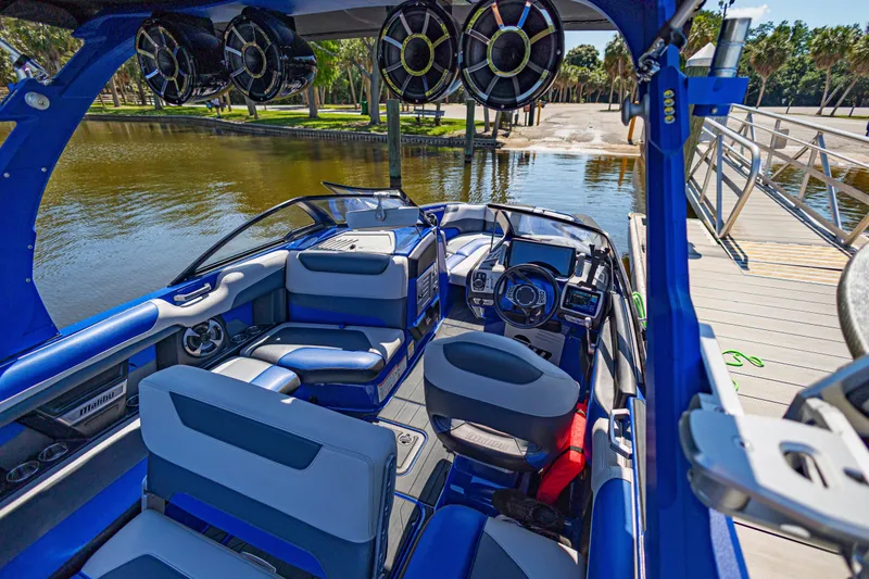 Slide: The Image of Interior of a 2017 Malibu M235 boat docked by a scenic waterfront. - 18