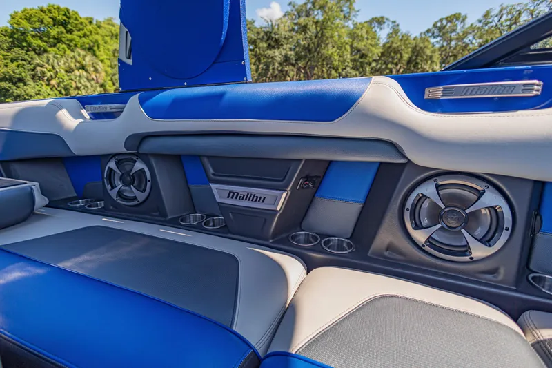 Slide: The Image of 2017 Malibu M235 interior with blue and gray seating, speakers, and cup holders. - 20