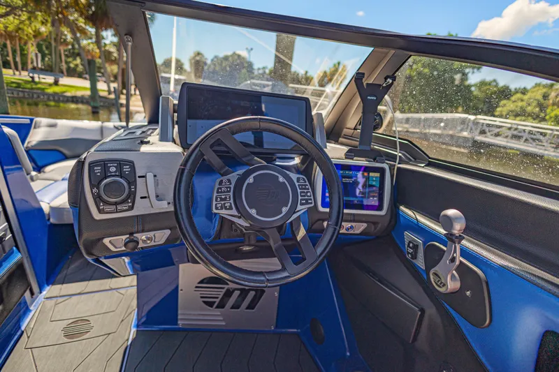 Slide: The Image of Interior view of a 2017 Malibu M235 boat cockpit with advanced controls and displays. - 22