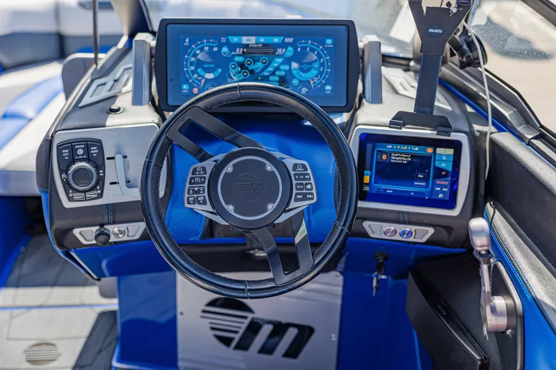 Slide: The Image of 2017 Malibu M235 boat dashboard with advanced controls and digital displays. - 25