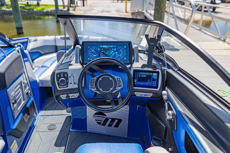 Slide: The Image of 2017 Malibu M235 boat cockpit with advanced navigation and control systems. - 31