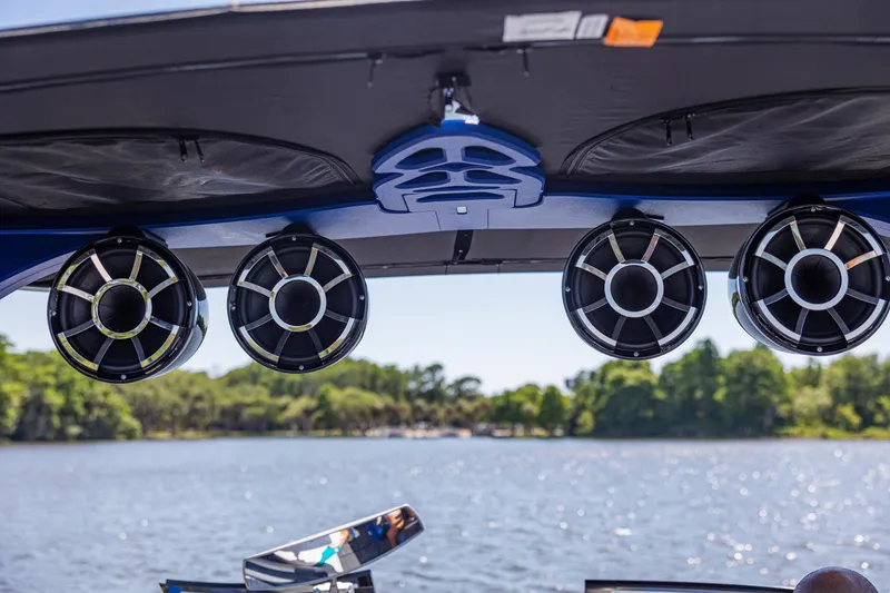 Slide: The Image of 2017 Malibu M235 boat speakers on a sunny lake, showcasing premium audio setup. - 35