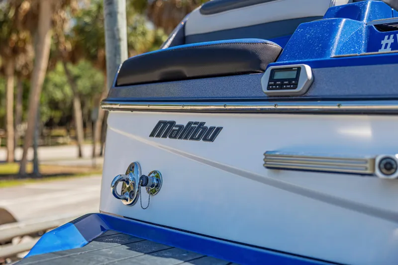 Slide: The Image of 2017 Malibu M235 boat rear view with logo and sleek design details. - 37