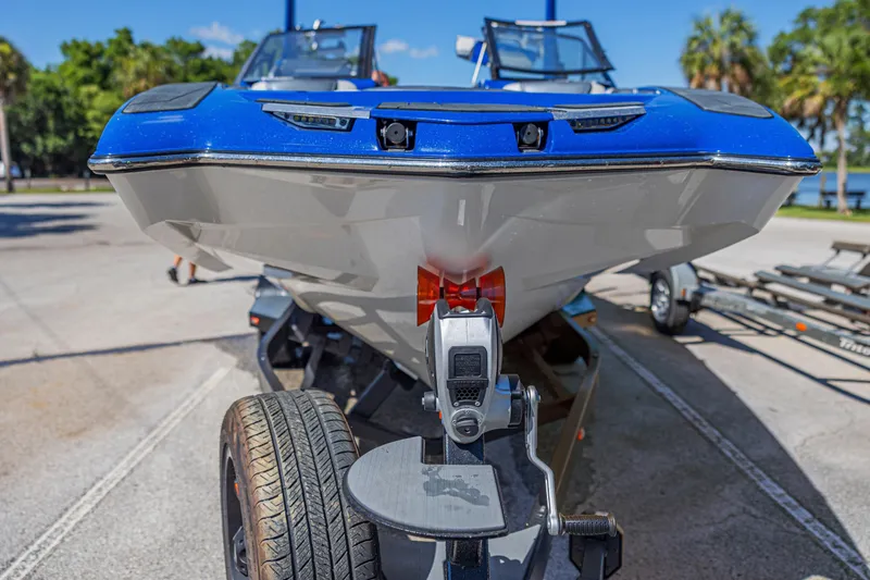 Slide: The Image of 2017 Malibu M235 boat on trailer, close-up view, sunny day. - 49