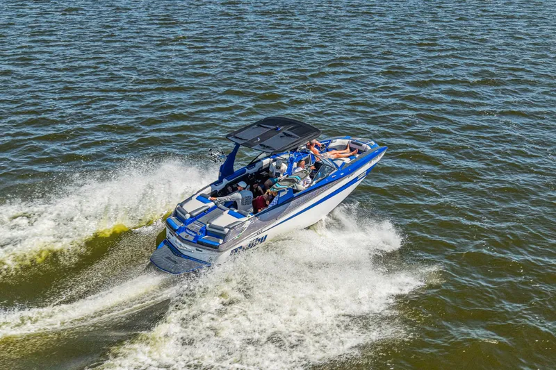 Slide: The Image of 2017 Malibu M235 boat cruising on open water with passengers enjoying the ride. - 8