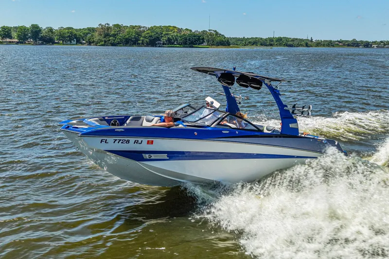 Slide: The Image of 2017 Malibu M235 boat cruising on a lake with passengers enjoying the ride. - 9