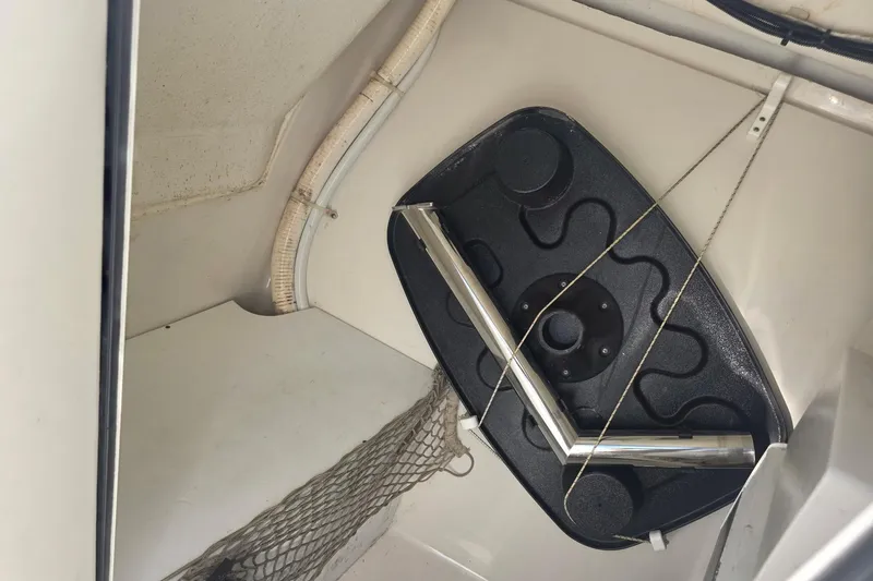 Slide: The Image of Interior storage compartment of a 2016 Sailfish 275 DC boat with netting and equipment. - 10
