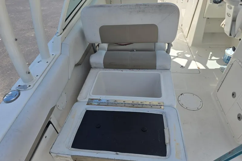 Slide: The Image of 2016 Sailfish 275 DC boat interior with open storage compartment and seating. - 6