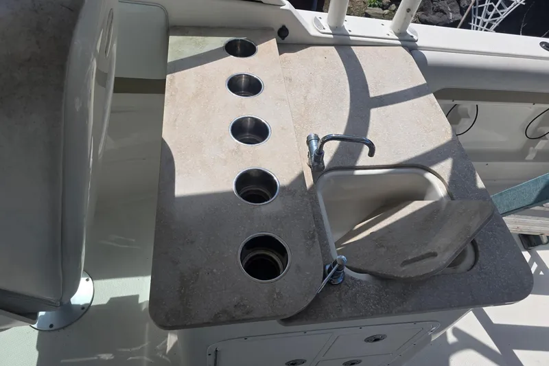 Slide: The Image of 2016 Sailfish 275 DC boat sink and cup holders on deck. - 8