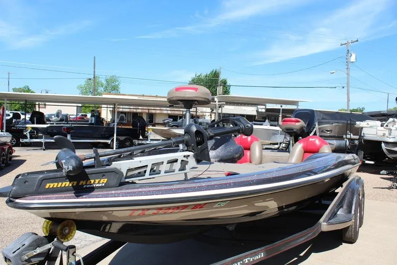 Slide: The Image of 2011 Ranger Z120 Comanche boat with Minn Kota motor in a dealership lot. - 6
