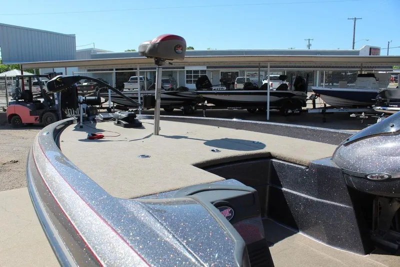 Slide: The Image of 2011 Ranger Z120 Comanche boat displayed outdoors with other boats in the background. - 9