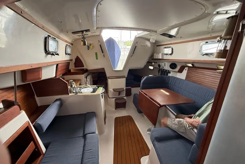 Slide: The Image of Interior of 1999 Seaward Eagle 32 yacht with cozy seating and wooden accents. - 13
