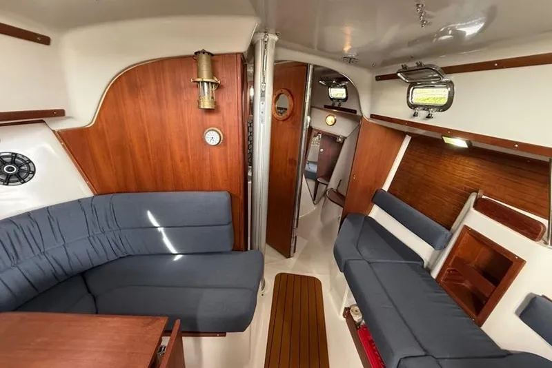 Slide: The Image of Interior of 1999 Seaward Eagle 32 yacht with wooden paneling and blue seating. - 14