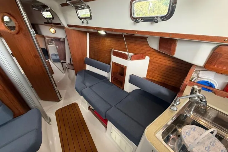 Slide: The Image of Interior of 1999 Seaward Eagle 32 yacht with cozy seating and wooden accents. - 15