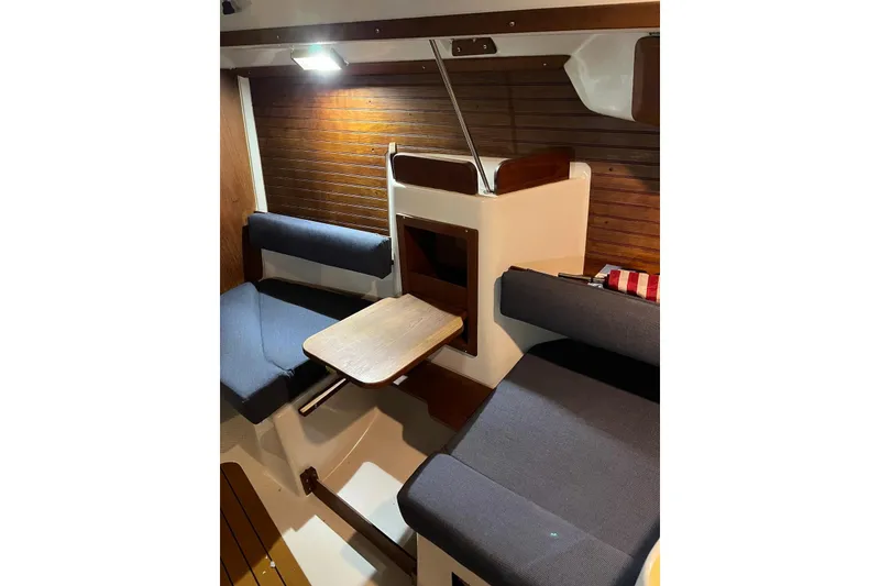 Slide: The Image of Interior of 1999 Seaward Eagle 32 yacht with cozy seating and wooden accents. - 16