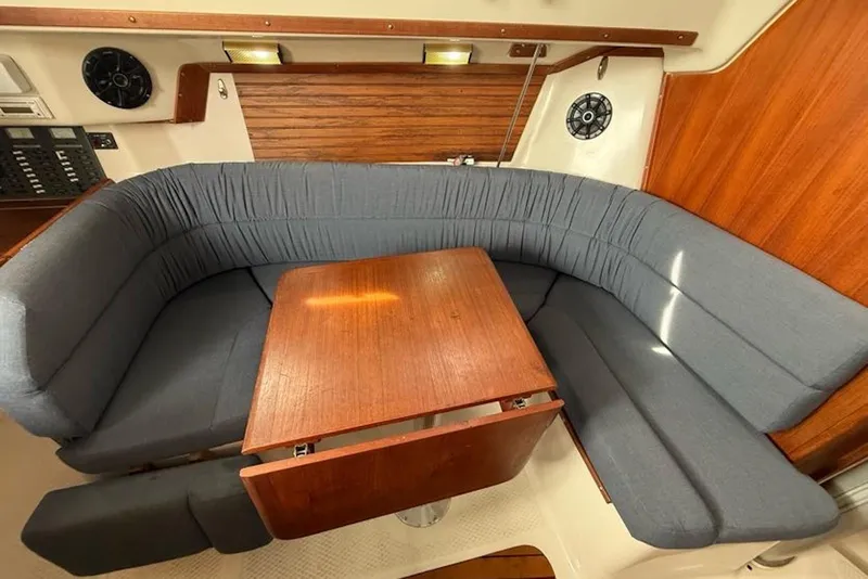 Slide: The Image of Cozy interior of 1999 Seaward Eagle 32 yacht with wooden table and cushioned seating. - 18