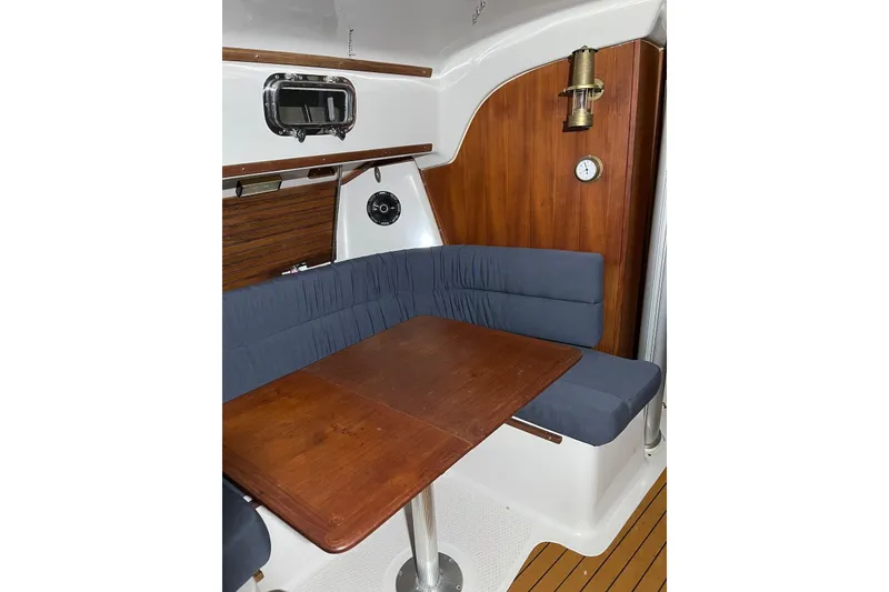 Slide: The Image of Interior of 1999 Seaward Eagle 32 yacht with wooden table and blue seating. - 19