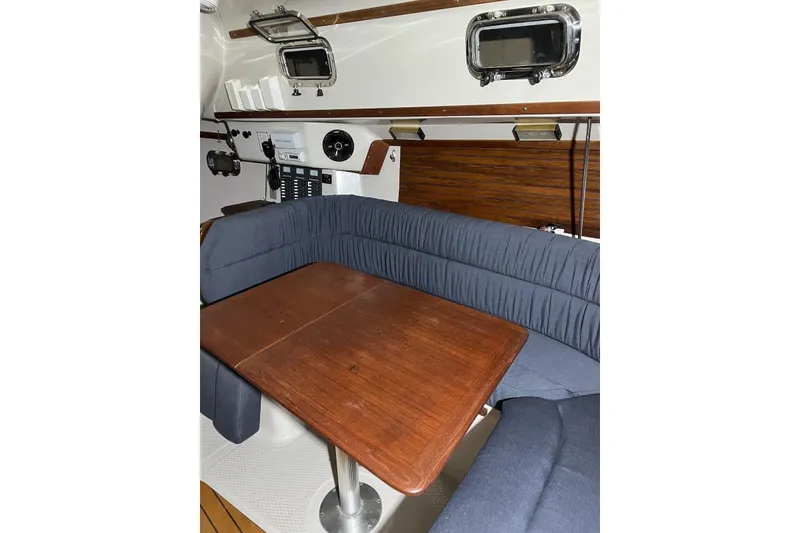 Slide: The Image of Interior of 1999 Seaward Eagle 32 yacht with wooden table and blue seating. - 20