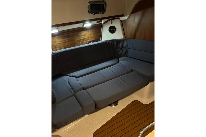 Slide: The Image of Interior of 1999 Seaward Eagle 32 yacht with blue cushioned seating. - 21