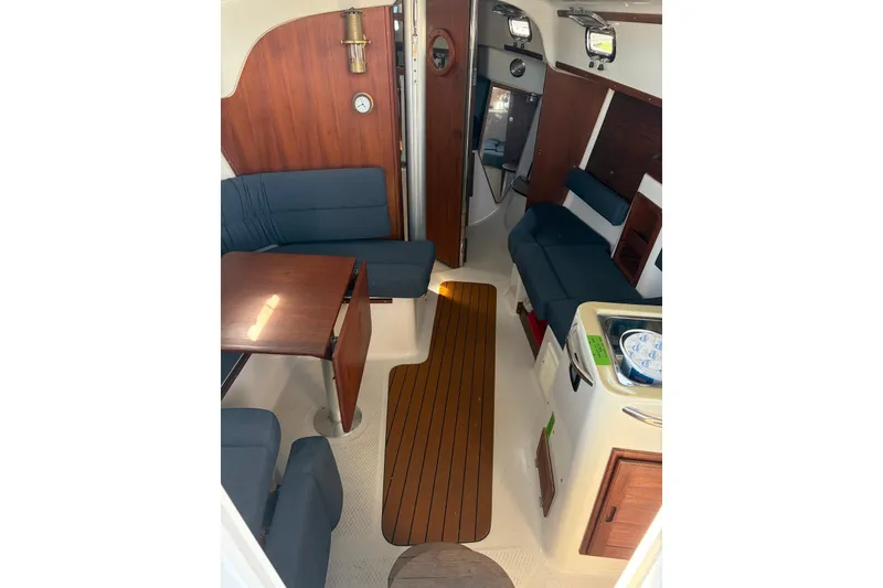 Slide: The Image of Interior of 1999 Seaward Eagle 32 yacht with wooden accents and blue seating. - 23