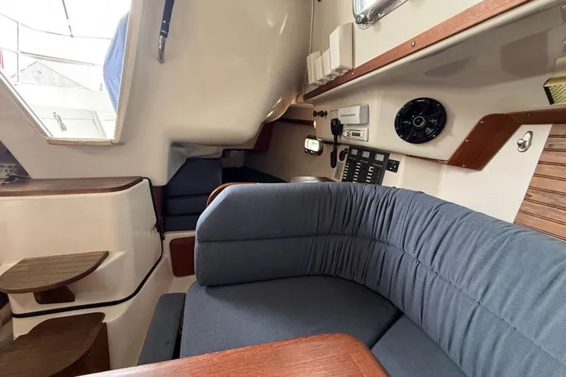 Slide: The Image of Interior of 1999 Seaward Eagle 32 yacht with blue seating and wooden accents. - 24