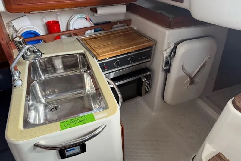 Slide: The Image of 1999 Seaward Eagle 32 yacht kitchen with sink, stove, and microwave. - 25