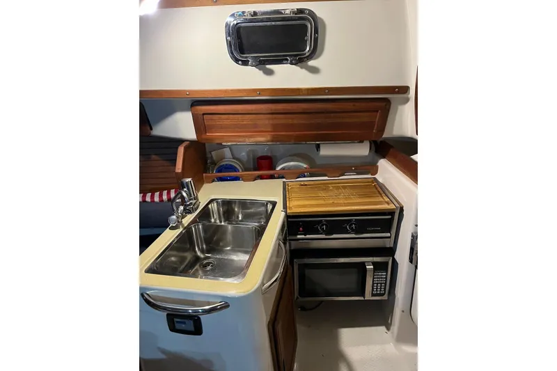 Slide: The Image of 1999 Hake Yachts Seaward Eagle 32 galley with sink, stove, and microwave. - 29