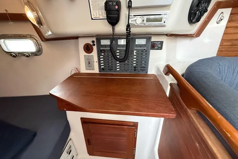Slide: The Image of 1999 Seaward Eagle 32 yacht interior with navigation panel and wooden table. - 31