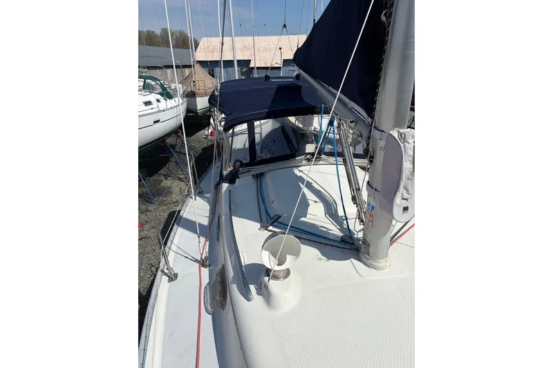 Slide: The Image of 1999 Seaward Eagle 32 sailboat deck with rigging and canopy, docked at marina. - 7