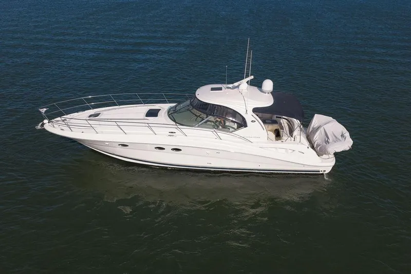 Slide: The Image of 2005 Sea Ray 420 Sundancer yacht cruising on open water. - 0