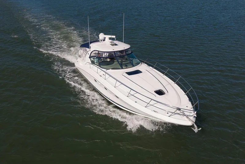 Slide: The Image of 2005 Sea Ray 420 Sundancer cruising on open water, showcasing sleek design and performance. - 11