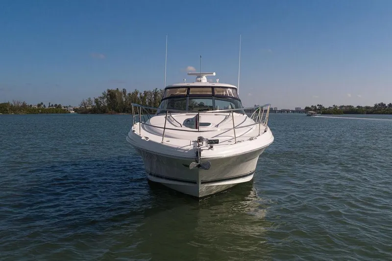 Slide: The Image of 2005 Sea Ray 420 Sundancer yacht on calm water, clear sky background. - 17