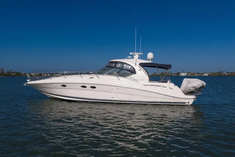 Slide: The Image of 2005 Sea Ray 420 Sundancer yacht on calm water under clear blue sky. - 18