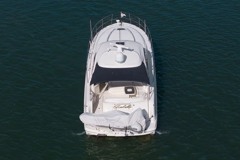 Slide: The Image of 2005 Sea Ray 420 Sundancer yacht cruising on open water, aerial view. - 2