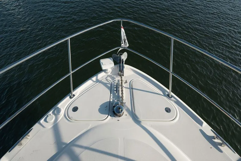 Slide: The Image of Bow view of 2005 Sea Ray 420 Sundancer yacht on calm water. - 22
