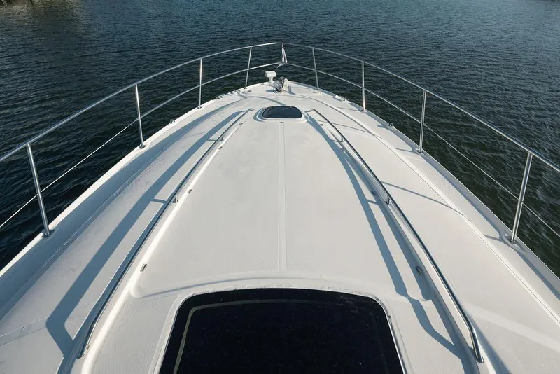 Slide: The Image of 2005 Sea Ray 420 Sundancer yacht deck overlooking calm waters. - 23
