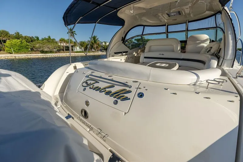 Slide: The Image of 2005 Sea Ray 420 Sundancer yacht docked, featuring luxurious seating and sleek design. - 25