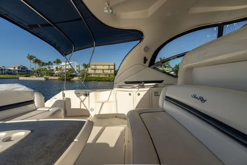Slide: The Image of Interior view of 2005 Sea Ray 420 Sundancer yacht with seating and waterfront backdrop. - 26