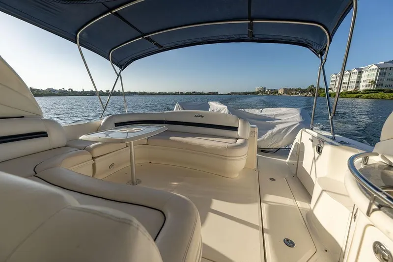 Slide: The Image of 2005 Sea Ray 420 Sundancer yacht interior with seating and table, cruising on a sunny day. - 28