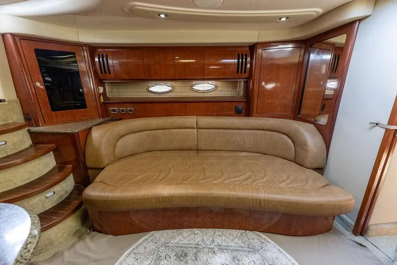 Slide: The Image of Luxurious interior of 2005 Sea Ray 420 Sundancer with leather seating and wooden cabinetry. - 31
