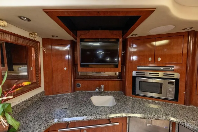 Slide: The Image of Luxurious 2005 Sea Ray 420 Sundancer yacht interior with granite countertops and modern appliances. - 32
