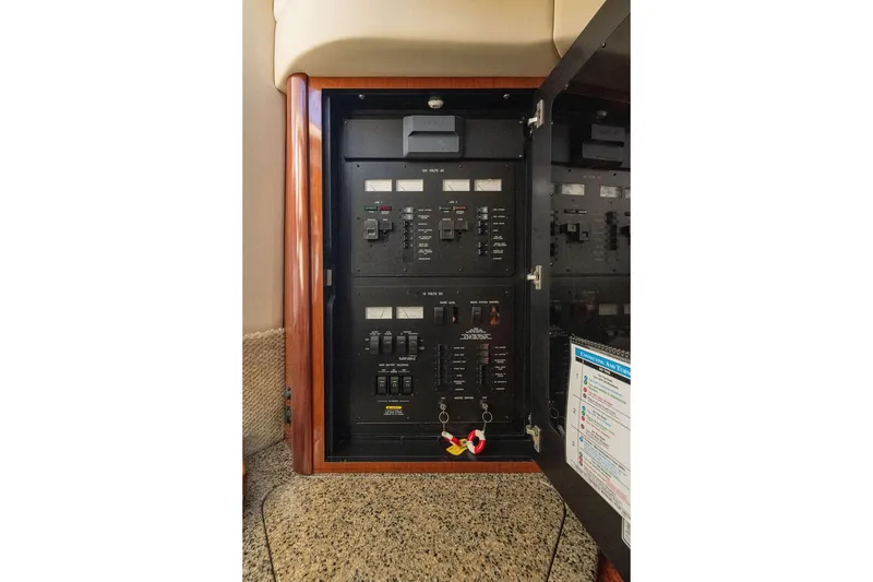 Slide: The Image of Electrical panel inside 2005 Sea Ray 420 Sundancer yacht, featuring switches and controls. - 39